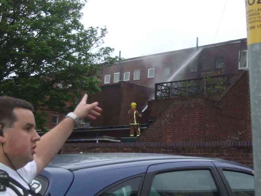 Fire crews working at rear access to upsairs flats in Aldridge